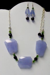 Chunk of chalcedony centered on labradorite beads with sterling chain and findings.